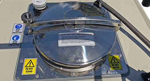 The circular access lid into the main liquid tank is constructed of stainless steel (8000 Series).